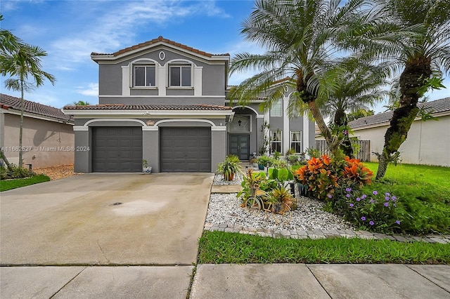 mediterranean / spanish-style home with a garage