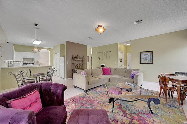 tiled living room with a textured ceiling