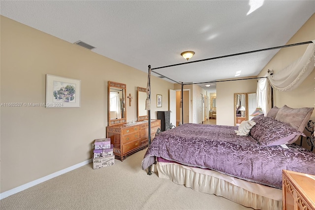 bedroom with a textured ceiling and carpet