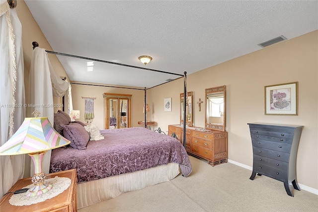 carpeted bedroom featuring a textured ceiling