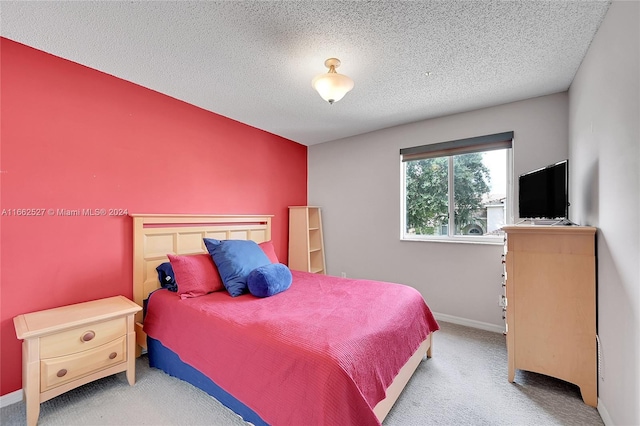 bedroom with a textured ceiling and carpet floors