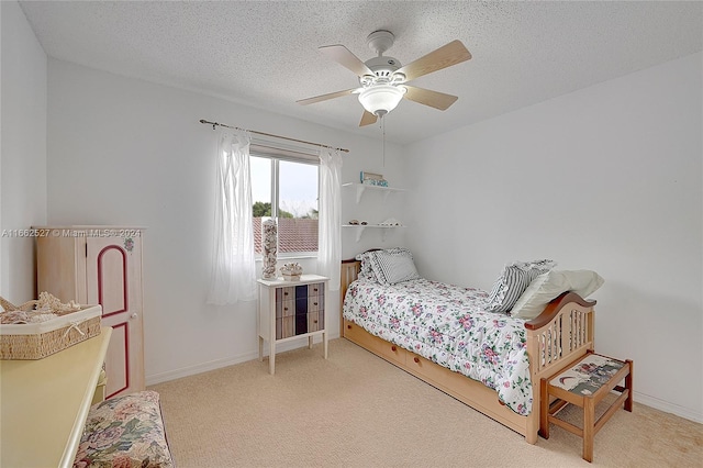 bedroom featuring ceiling fan, carpet flooring, and a textured ceiling