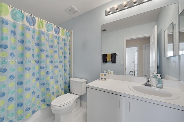 bathroom featuring vanity, toilet, and tile patterned floors