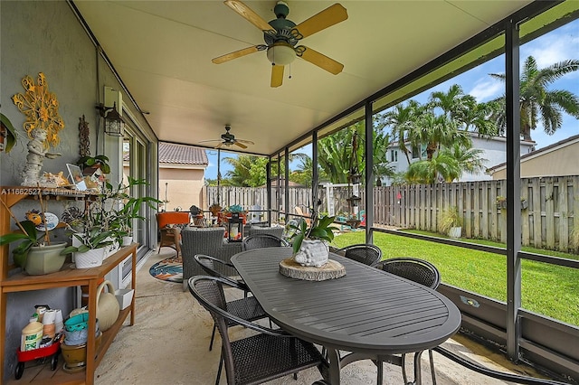 sunroom featuring ceiling fan and plenty of natural light