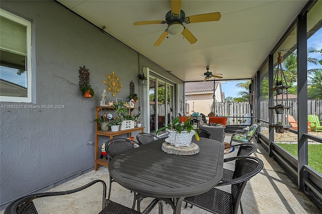 sunroom / solarium featuring ceiling fan