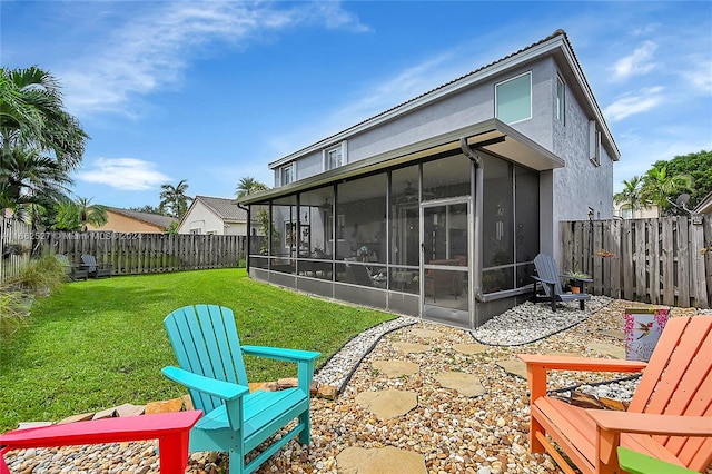 back of house featuring a sunroom and a yard