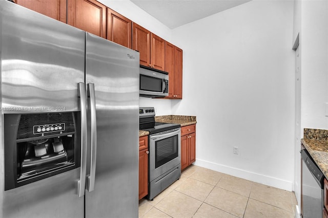 kitchen with light tile patterned floors, sink, stone countertops, stainless steel appliances, and crown molding