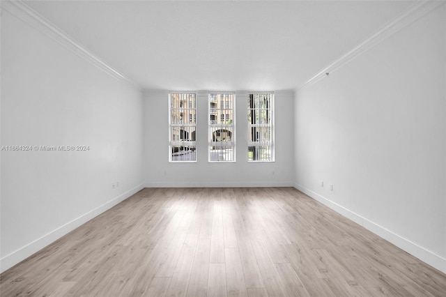 unfurnished living room featuring light hardwood / wood-style floors, ornamental molding, and a textured ceiling