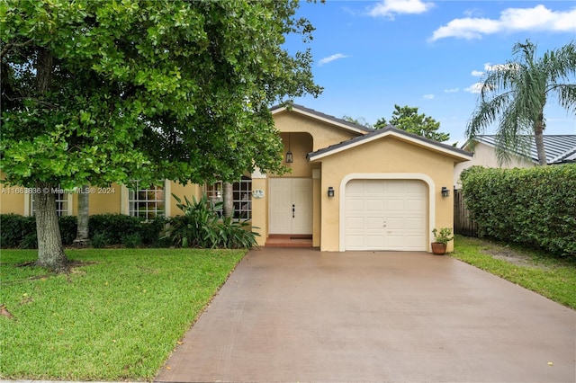 view of front of house with a garage and a front lawn