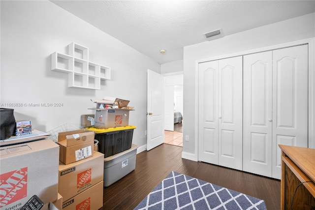 interior space featuring a textured ceiling and dark hardwood / wood-style flooring