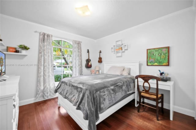 bedroom featuring crown molding and dark hardwood / wood-style flooring