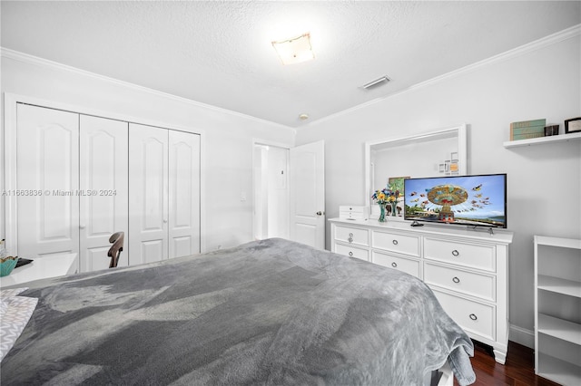 bedroom featuring a textured ceiling, a closet, crown molding, and dark wood-type flooring