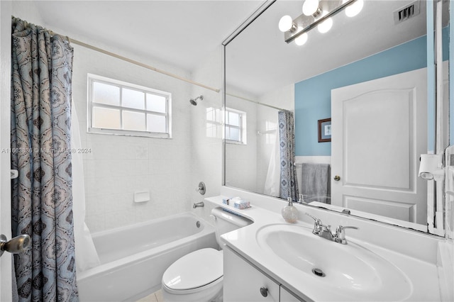 full bathroom featuring shower / bath combo, vanity, and toilet