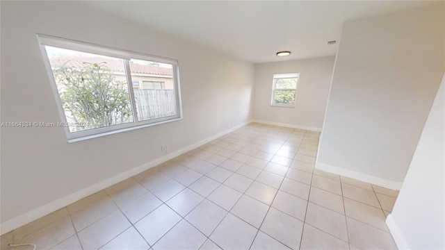 spare room featuring light tile patterned floors