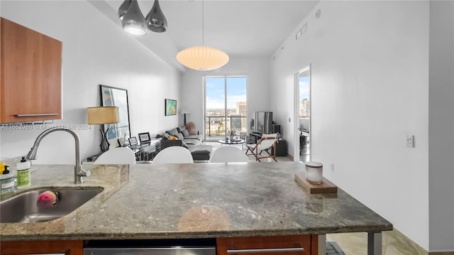 kitchen with dishwasher, a chandelier, sink, hanging light fixtures, and dark stone countertops