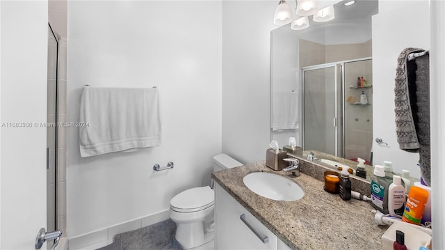 bathroom featuring tile patterned floors, walk in shower, vanity, and toilet