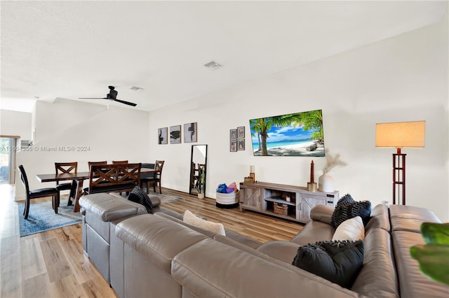 living room featuring light hardwood / wood-style flooring and ceiling fan