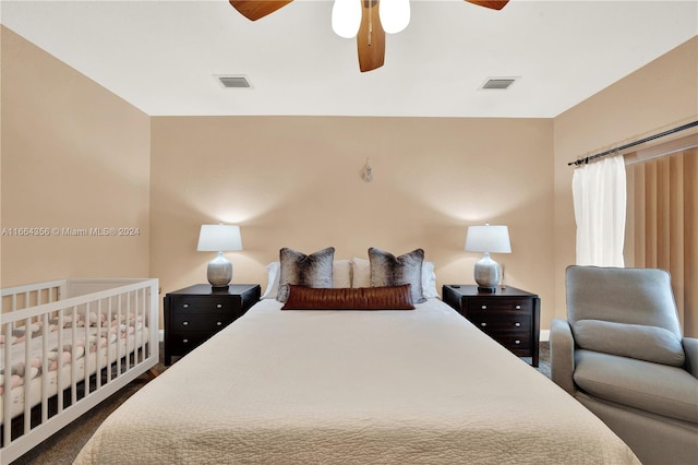 bedroom with dark colored carpet and ceiling fan