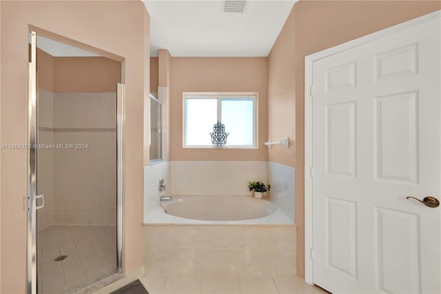 bathroom featuring tile patterned flooring and separate shower and tub