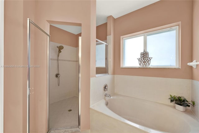 bathroom featuring separate shower and tub