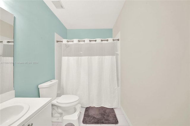 bathroom featuring tile patterned floors, vanity, and toilet