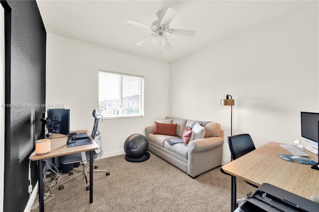 carpeted office space featuring ceiling fan