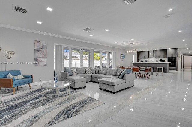 living room featuring french doors and ornamental molding