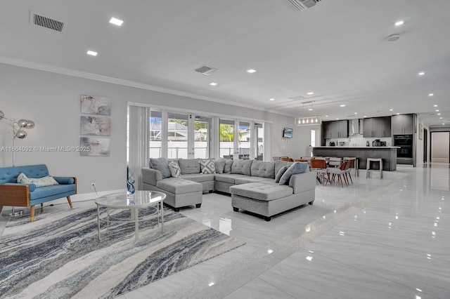 living area featuring visible vents, marble finish floor, and crown molding