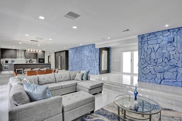 living room with ornamental molding and light tile patterned flooring