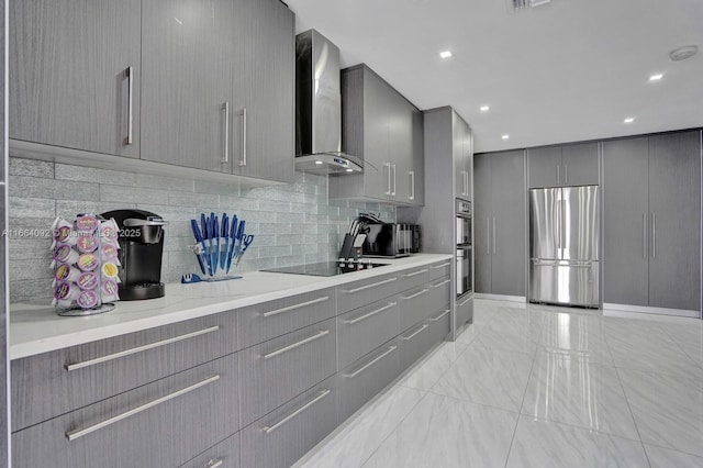 kitchen featuring gray cabinetry, appliances with stainless steel finishes, wall chimney exhaust hood, modern cabinets, and tasteful backsplash