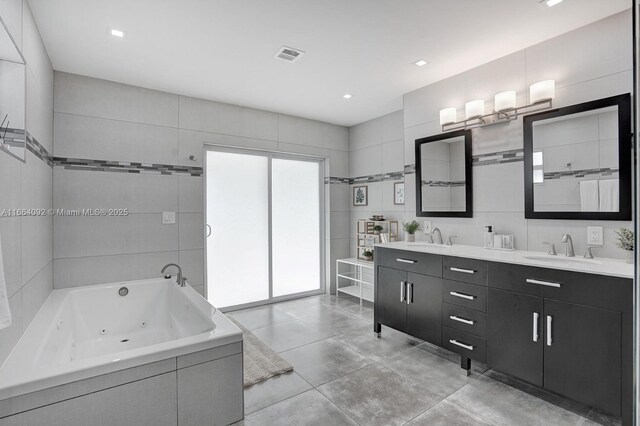 bathroom with tile walls, vanity, and a shower with shower door