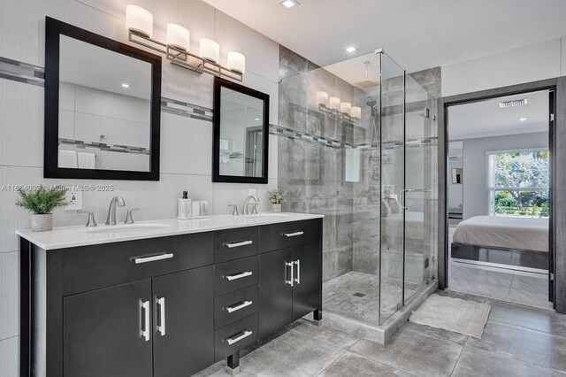 full bathroom with tile walls, vanity, tiled shower / bath combo, toilet, and tile patterned floors