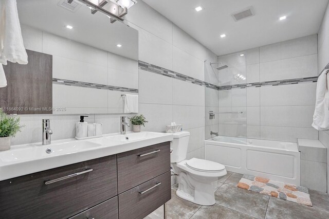 bathroom featuring vanity, tile walls, toilet, and an enclosed shower