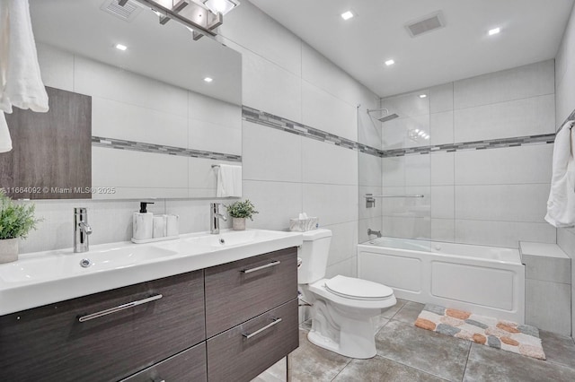 full bath featuring visible vents, shower / tub combination, double vanity, tile walls, and a sink