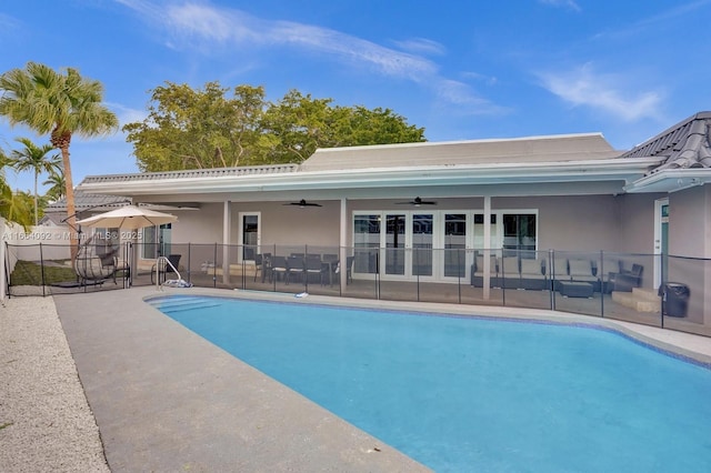 view of pool featuring a fenced in pool, fence, ceiling fan, and a patio area