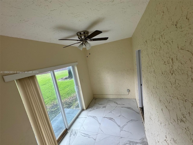 unfurnished room with a textured ceiling and ceiling fan