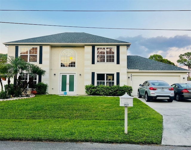 view of front of home featuring a front lawn and a garage