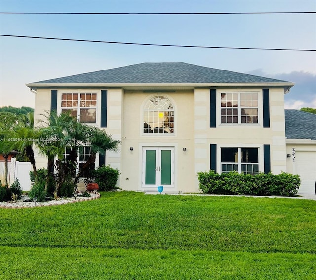 view of front of property featuring a garage and a front lawn