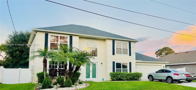 view of front of property featuring a yard and a garage