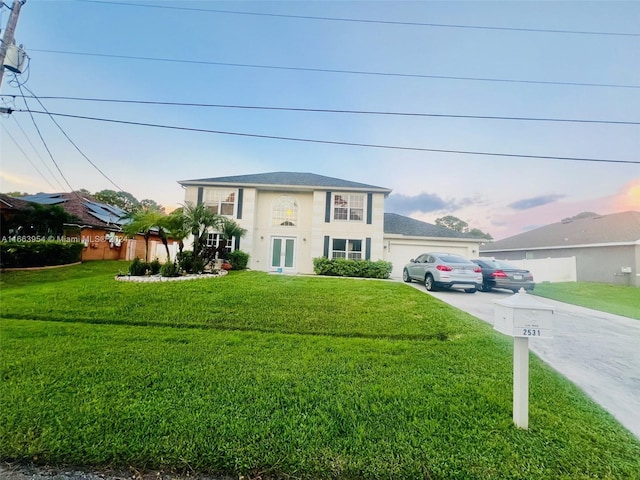 view of front facade featuring a garage and a front lawn