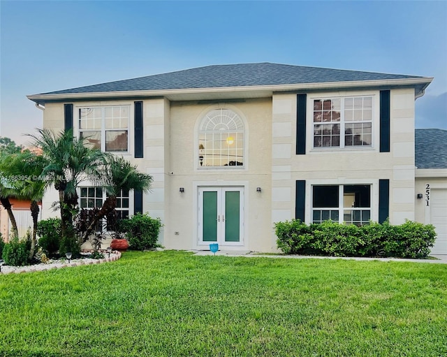 view of front of property with a front yard and a garage