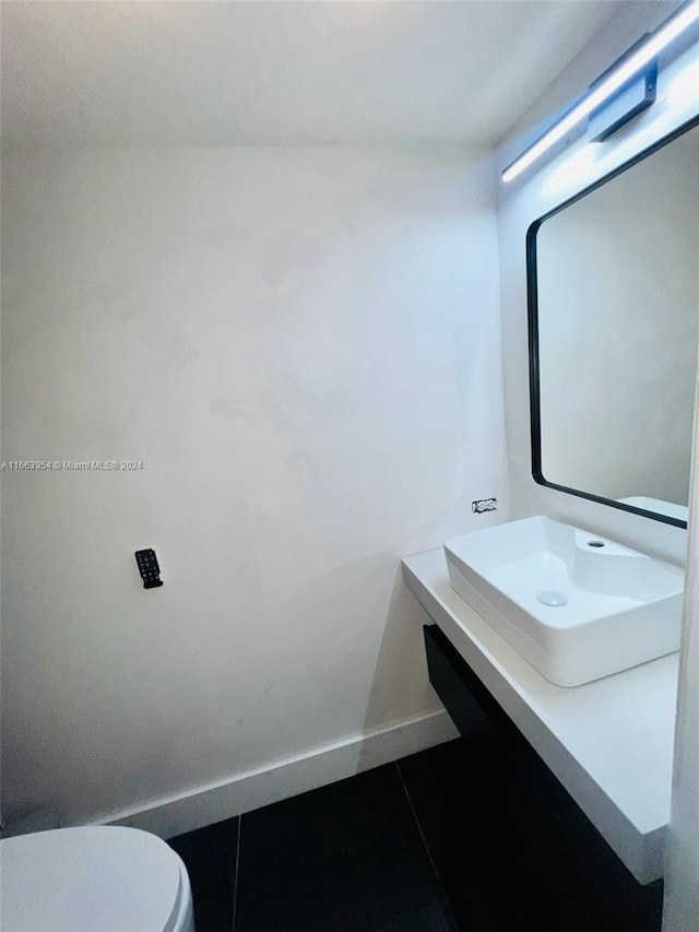 bathroom featuring vanity, toilet, and tile patterned floors