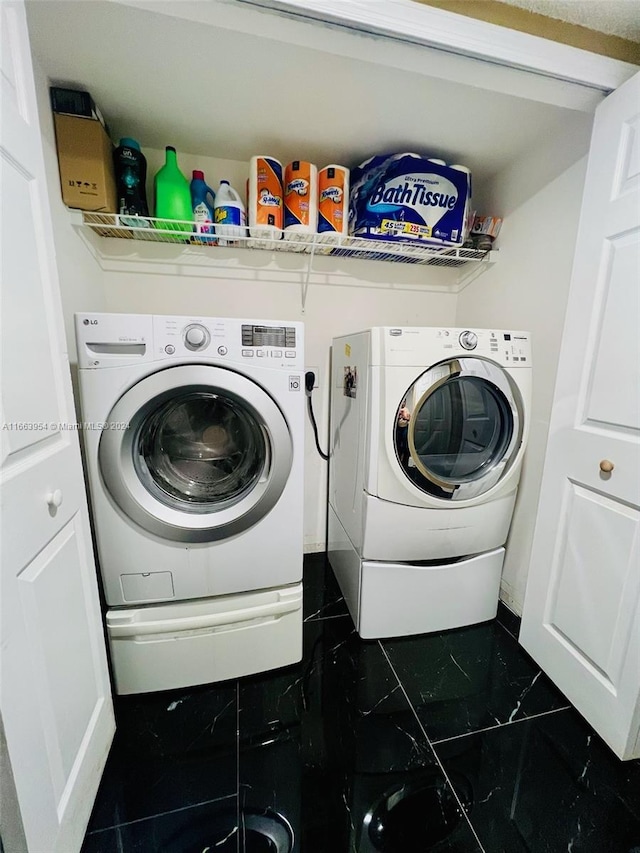 clothes washing area featuring independent washer and dryer