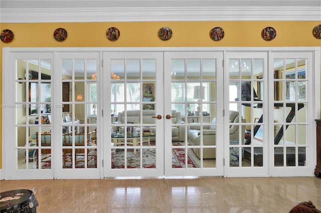 entryway featuring crown molding and french doors