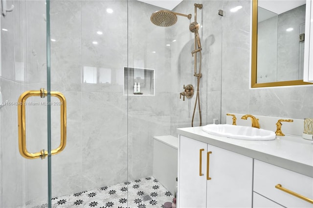 bathroom featuring vanity, tile walls, and a shower with shower door