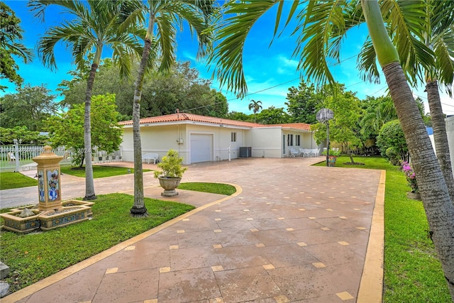 view of front of house with a garage and a front lawn