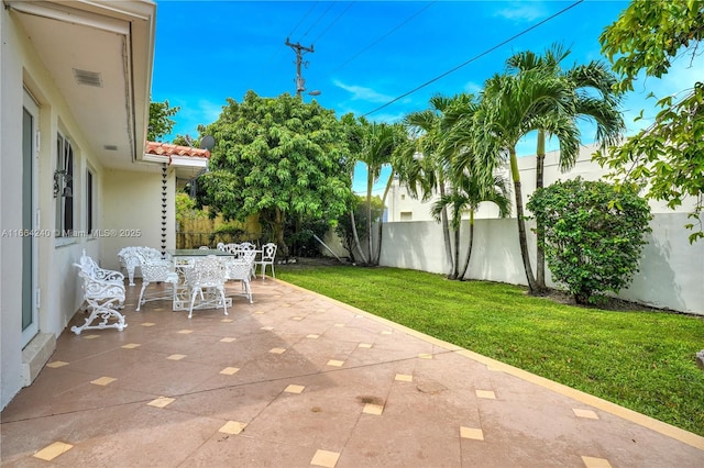 1407 San Marco Ave, Coral Gables, FL 33134 - view of patio / terrace featuring a fenced backyard, outdoor dining area, and visible vents
