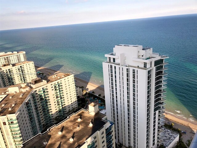 aerial view featuring a view of the beach and a water view