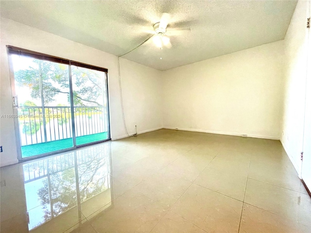 empty room featuring a textured ceiling and ceiling fan