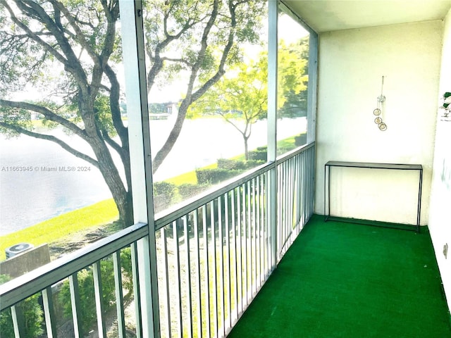 unfurnished sunroom with a water view and a healthy amount of sunlight